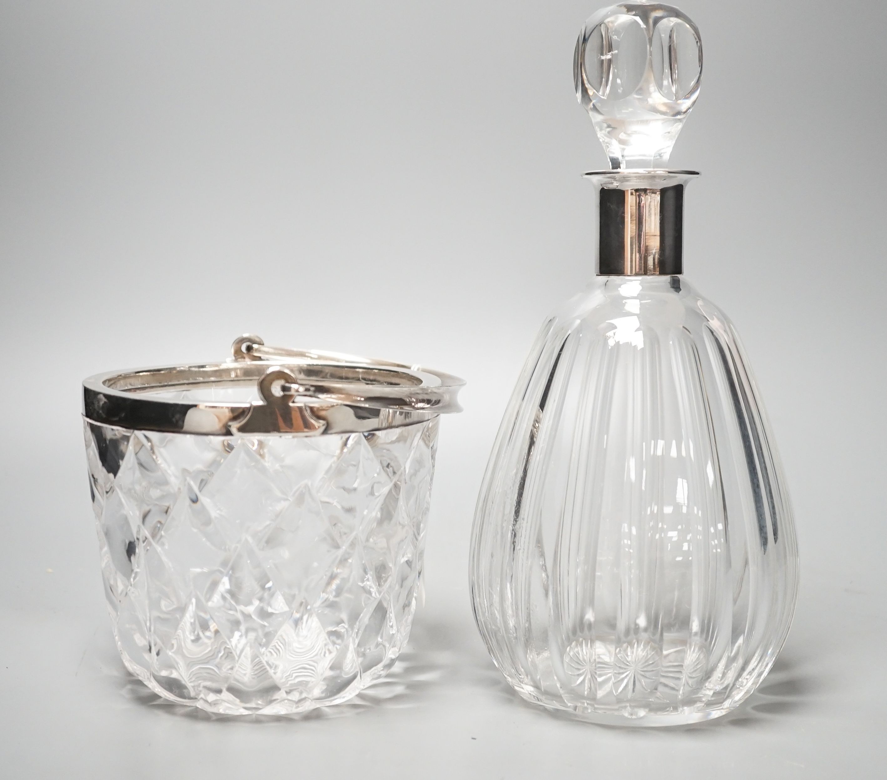 A German 835 white metal mounted glass decanter and a late Victorian silver mounted glass vase with handle.